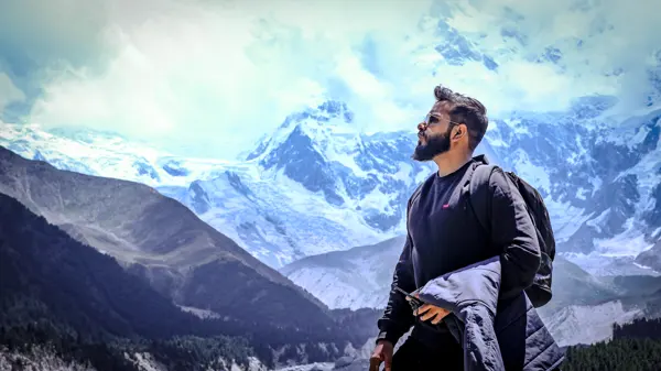 Ameer in front of a dramatic mountain landscape